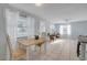 Light-filled dining area features neutral decor, tile flooring, and seamless access to the living room at 128 Oakridge Ave, Edgewater, FL 32132