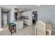 Open concept kitchen features granite countertops, white cabinets and stainless appliances at 128 Oakridge Ave, Edgewater, FL 32132