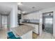 Bright kitchen with granite counters, stainless appliances, and island seating at 128 Oakridge Ave, Edgewater, FL 32132