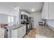 Modern kitchen featuring stainless appliances, granite counters and breakfast bar at 128 Oakridge Ave, Edgewater, FL 32132