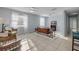 Open-concept living room with tile floors, neutral decor, and lots of natural light at 128 Oakridge Ave, Edgewater, FL 32132