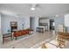 Bright living room leading to kitchen with tile floors and a comfortable seating area at 128 Oakridge Ave, Edgewater, FL 32132