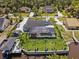 Aerial view of expansive property with pool, canal access, and lush landscaping at 1446 Stone Trl, Enterprise, FL 32725