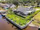 An aerial view of a waterfront property featuring a pool and beautifully manicured lawn at 1446 Stone Trl, Enterprise, FL 32725