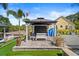 Well-manicured backyard with a gazebo, outdoor seating, and serene waterfront views at 1446 Stone Trl, Enterprise, FL 32725