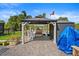 Covered outdoor patio area features ample seating and tranquil view of waterway at 1446 Stone Trl, Enterprise, FL 32725