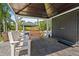 Covered patio with comfortable seating, offering stunning waterfront and landscape view at 1446 Stone Trl, Enterprise, FL 32725