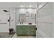 This main bathroom features a double sink vanity, a walk-in shower and stylish lighting at 1446 Stone Trl, Enterprise, FL 32725