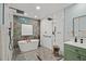 Main bathroom features a standalone tub, double shower, and stylish green vanity with white countertop at 1446 Stone Trl, Enterprise, FL 32725