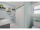 Clean bathroom featuring shower, shelves, with decorative plants at 1446 Stone Trl, Enterprise, FL 32725
