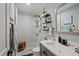 Bright bathroom features a walk-in shower with white marble tiles, sleek fixtures and stylish decor at 1446 Stone Trl, Enterprise, FL 32725
