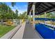 Enjoy waterfront living with this boat dock featuring a covered boat lift, seating area, and direct water access at 1446 Stone Trl, Enterprise, FL 32725