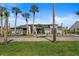 Beautiful front yard with meticulously kept landscaping and a long driveway leading to a stunning home at 1446 Stone Trl, Enterprise, FL 32725