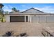 The house's bricked two-car garage has a large driveway, a side door, and plenty of parking space at 1446 Stone Trl, Enterprise, FL 32725