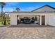 A blue SUV is parked inside the home's two-car garage, which features storage and wall-mounted organizers at 1446 Stone Trl, Enterprise, FL 32725