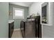 Stylish laundry room with modern appliances, white countertops, and ample storage at 1446 Stone Trl, Enterprise, FL 32725