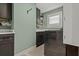 Functional laundry room with stainless steel washer and dryer and modern cabinets at 1446 Stone Trl, Enterprise, FL 32725