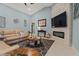Comfortable living room with stone fireplace, large TV, and stylish decor at 1446 Stone Trl, Enterprise, FL 32725