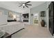 Spacious main bedroom featuring modern fireplace, ceiling fan, and access to an ensuite bathroom at 1446 Stone Trl, Enterprise, FL 32725