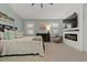 Bright main bedroom showcases neutral decor, an electric fireplace, ceiling fan and shuttered windows at 1446 Stone Trl, Enterprise, FL 32725