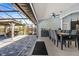 Covered outdoor patio with pavers, seating area, offering a seamless transition from indoor living at 1446 Stone Trl, Enterprise, FL 32725