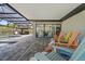 Covered patio space features a gazebo, a set of sliding glass doors, and multiple colorful Adirondack chairs at 1446 Stone Trl, Enterprise, FL 32725