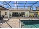 The patio area by the pool has a set of sliding glass doors with a view into the home's dining and living room at 1446 Stone Trl, Enterprise, FL 32725