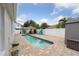 A stunning backyard with pool, paver patio, tiki bar, shed, and lush landscaping for ultimate outdoor enjoyment at 1491 Nappa Dr, Port Orange, FL 32128