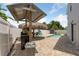 A stunning backyard oasis showcasing a tiki bar, an outdoor grill, and a crystal-clear pool for ultimate relaxation at 1491 Nappa Dr, Port Orange, FL 32128