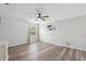 A spacious bedroom featuring wood floors, a ceiling fan, and large window creating an airy, inviting space at 1491 Nappa Dr, Port Orange, FL 32128