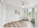 Bedroom with light hardwood floors, neutral walls, one window with natural light, and a ceiling fan at 1491 Nappa Dr, Port Orange, FL 32128