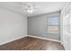This bedroom offers wood floors, a ceiling fan, and a window bringing in lots of natural light at 1491 Nappa Dr, Port Orange, FL 32128