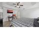 Spacious bedroom featuring a modern ceiling fan and a functional workspace with a desk and television at 1491 Nappa Dr, Port Orange, FL 32128