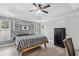 Comfortable bedroom with unique accent wall, wood-look flooring, and natural light providing a serene atmosphere at 1491 Nappa Dr, Port Orange, FL 32128