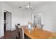 Bright dining room featuring hardwood floors, a stylish chandelier, and neutral tones for a welcoming atmosphere at 1491 Nappa Dr, Port Orange, FL 32128