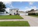 Inviting home featuring a spacious lawn and classic design elements, complemented by a two-car garage at 1491 Nappa Dr, Port Orange, FL 32128