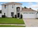 Charming two-story home with a well-manicured lawn, two-car garage, and classic architectural details at 1491 Nappa Dr, Port Orange, FL 32128