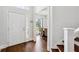 Inviting foyer with hardwood floors, a staircase, and an open view to a sunlit dining room at 1491 Nappa Dr, Port Orange, FL 32128