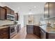 Stylish kitchen with dark wood cabinetry, stainless steel appliances, and an open layout at 1491 Nappa Dr, Port Orange, FL 32128