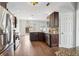 Modern kitchen with stainless steel appliances, dark wood cabinets, and an open view to the backyard at 1491 Nappa Dr, Port Orange, FL 32128