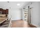A sun-filled kitchen features a breakfast bar and dark brown cabinetry giving it an elegant and modern feel at 1491 Nappa Dr, Port Orange, FL 32128