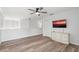 Open-concept living room with a modern color palette with wood-look floors and a charming white console at 1491 Nappa Dr, Port Orange, FL 32128