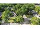 Aerial view showcases a neighborhood with mature trees and well-maintained homes at 1523 Red Plum Holw, Deland, FL 32720