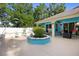Serene backyard with a patio, central planter, and lush landscaping at 1523 Red Plum Holw, Deland, FL 32720