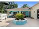 Landscaped backyard features a covered patio and central planter at 1523 Red Plum Holw, Deland, FL 32720