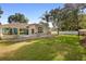 Expansive backyard with a covered patio and lush greenery provides privacy at 1523 Red Plum Holw, Deland, FL 32720