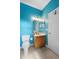 Bright bathroom with blue walls, a toilet, vanity, and tiled floor at 1523 Red Plum Holw, Deland, FL 32720