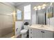 Classic bathroom with a glass-enclosed shower, white vanity, and commode at 1523 Red Plum Holw, Deland, FL 32720