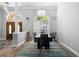 Formal dining room featuring a wooden door, stylish lighting, and a large window for ample natural light at 1523 Red Plum Holw, Deland, FL 32720
