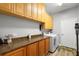 Functional laundry room featuring a washer, dryer, cabinets, and countertop space at 1523 Red Plum Holw, Deland, FL 32720